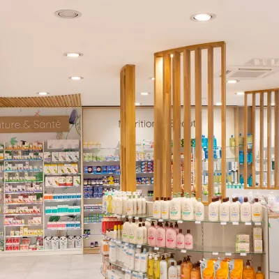 Espace Nature & Santé de la Pharmacie Berlioz avec mobilier bois et cloison décorative ajourée